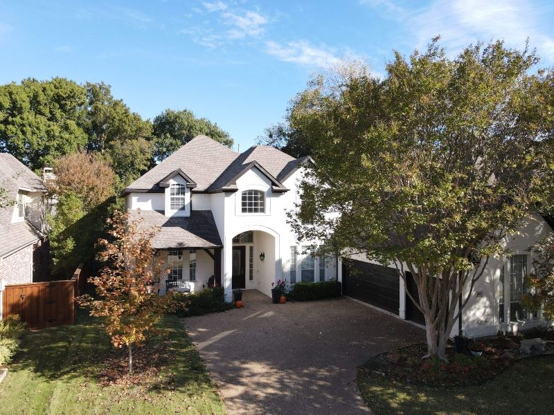 Residential roof project with mature landscaping