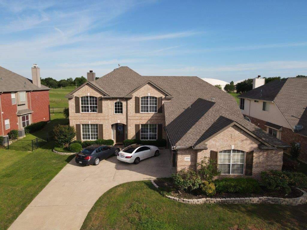 Two-story home with new shingle roof