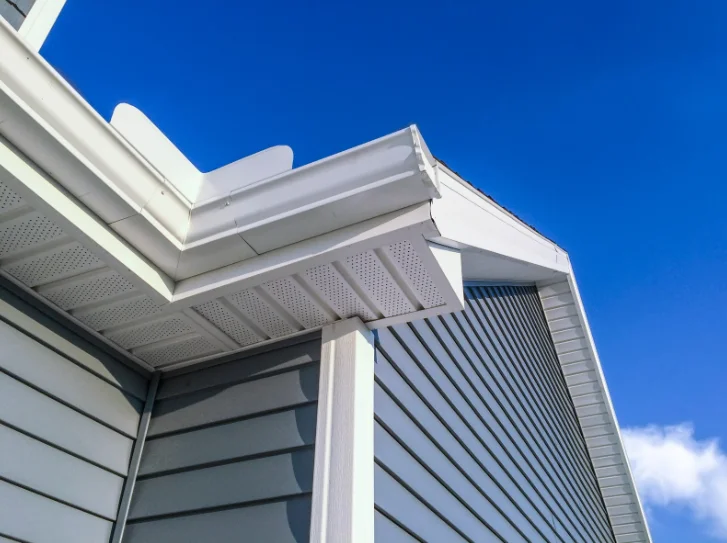 Soffit vents and roof eaves on a modern home with siding