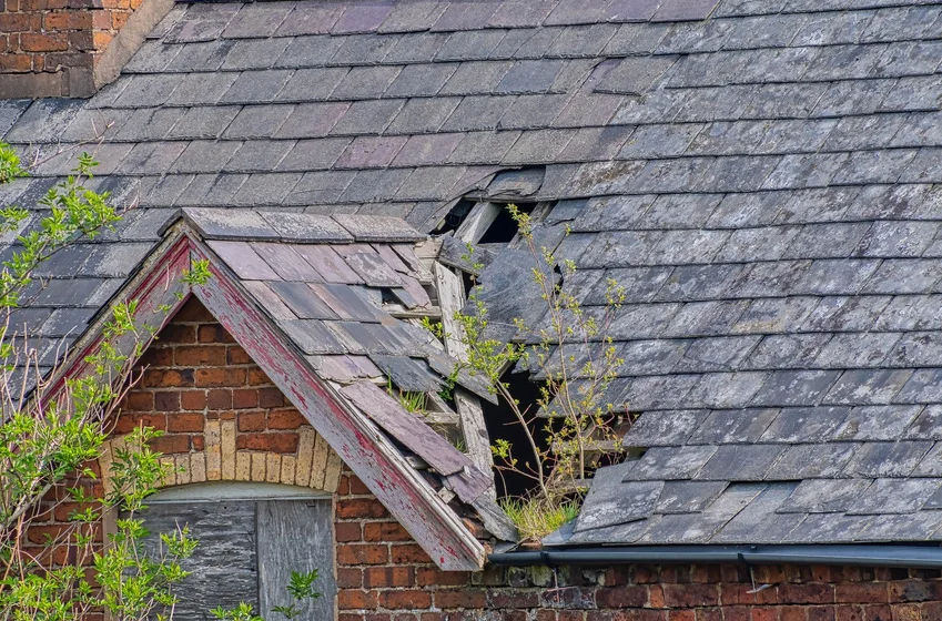 Aging roof with deteriorated and missing shingles