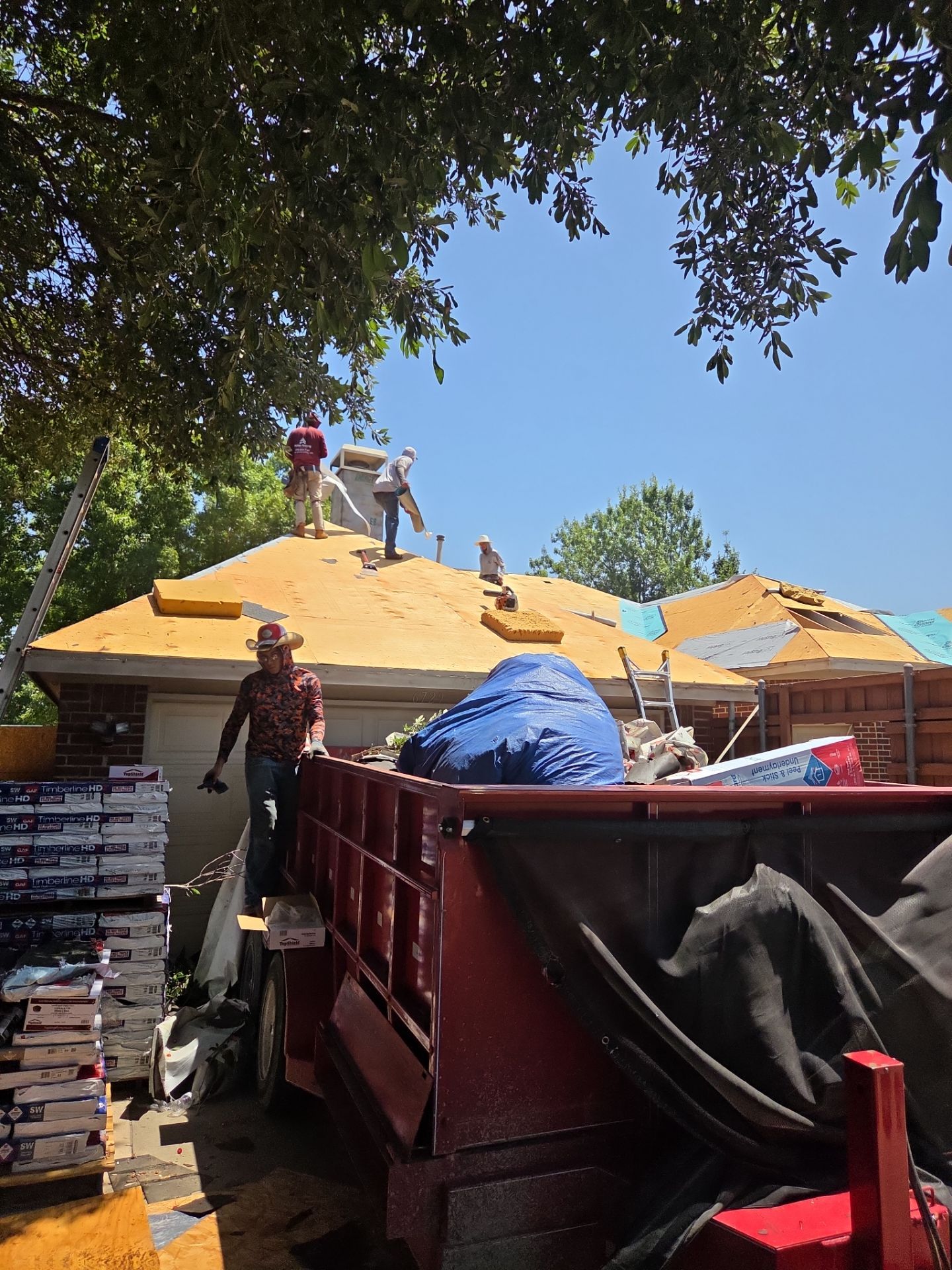 Roofing crew working on a residential roof replacement
