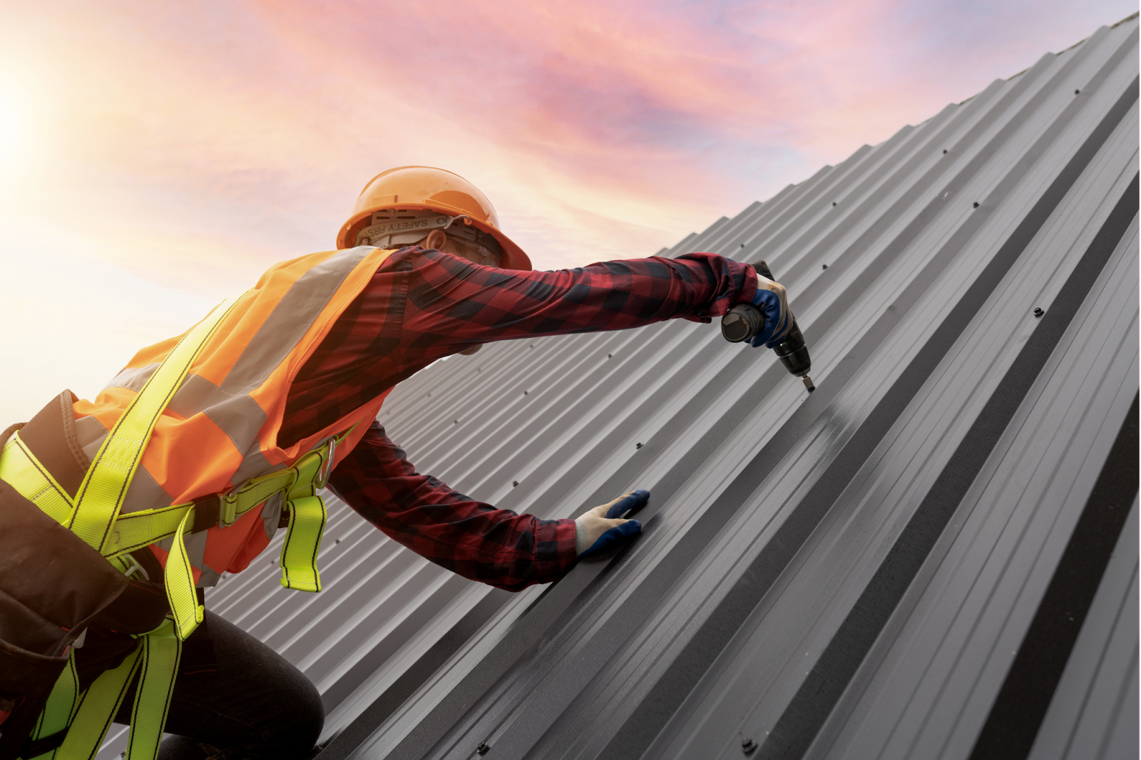 a man installing a metal roof