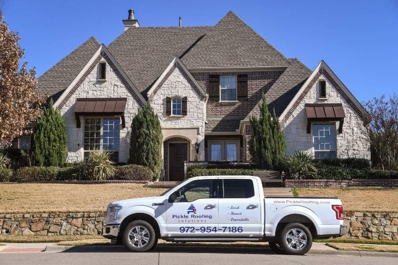 Pickle Roofing Solutions parked car near a house